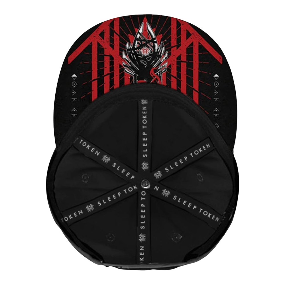 A black baseball cap shown from the front, featuring a red and black graphic design on the crown with a stylized horned figure and the word 'TOKEN' repeated on the black adjustable underbraces.